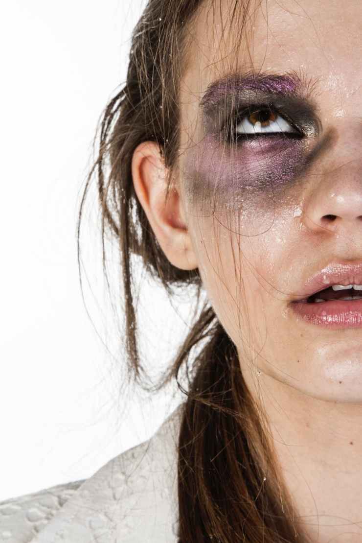 close up photo of woman with black and purple eye shadow